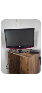 a flat screen tv sitting on top of a wooden stand at Le passage in Saint-Brieuc