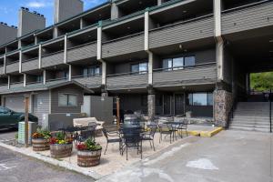 a building with tables and chairs in a parking lot at Switchback at Edelweiss in Whitefish