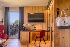a room with a desk with a chair and a bag at Hotel Haberl - Attersee in Attersee am Attersee