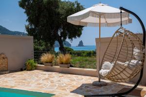 a hammock and an umbrella next to a pool at Tsanta house in Agios Gordios