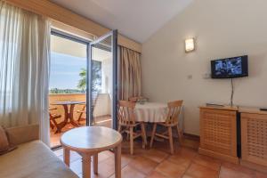a living room with a couch and a table at Apartments Bellevue Plava Laguna in Poreč