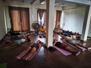 a group of people laying in a yoga class at Santoshi Guest House and Yoga Center in Pokhara