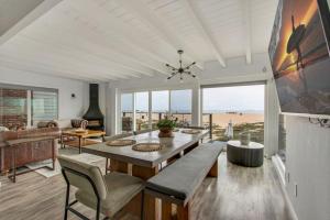 a dining room with a table and a view of the beach at Beachfront Condo on A LowKey Beach in Sunset Beach