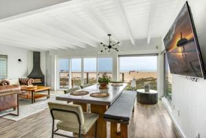 a living room with a table and a view of the beach at Beachfront Condo on A LowKey Beach in Sunset Beach