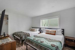 a bedroom with two beds and a window at Beachfront Condo on A LowKey Beach in Sunset Beach