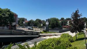 a view of a street with a bridge and a parking lot at Eden Apartament in Bucharest