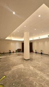 a large room with a pillar in the middle of a building at Kosala grand in Bhadrāchalam