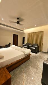 a bedroom with a bed and a living room at Kosala grand in Bhadrāchalam