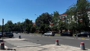 a street with cars parked on the side of the road at Eden Apartament in Bucharest +2 photos