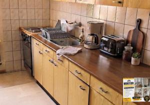 a kitchen with a wooden counter top with a stove at Herz Monteur City-Apartment Halberstadt Dom in Halberstadt