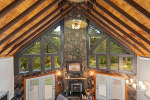a living room with windows and a stone wall at Stones Throw in Hill City