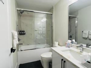 a bathroom with a shower and a toilet and a sink at Guest Suite in Mission in Mission +30 photos