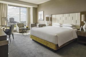 a hotel room with a large bed and a desk at Hyatt Regency Tysons Corner Center in Tysons Corner +21 photos