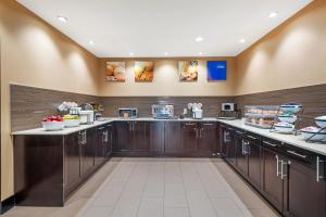 a large kitchen with wooden cabinets and appliances at Comfort Inn & Suites Airport North in Calgary