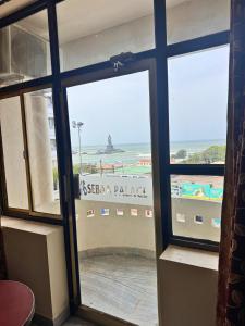 a window with a view of the beach from a room at HOTEL SEBAA PALACE in Kanyakumari
