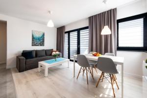 a living room with a couch and a table at AWO Apartamenty in Łeba