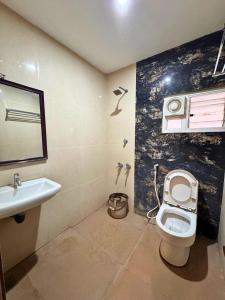 a bathroom with a toilet and a sink at HOTEL SEBAA PALACE in Kanyakumari +47 photos