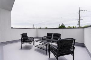a patio with two chairs and a couch and a table at The Terrace MAKINO in Takashima