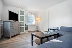 a living room with a couch and a tv and a table at Ankerhaus 1 in Trent
