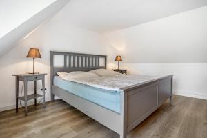 a bedroom with a large bed and two night stands at Ankerhaus 1 in Trent