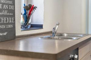 a kitchen counter with a sink and a mirror at Ankerhaus 1 in Trent +19 photos