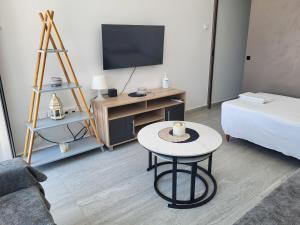 a living room with a bed and a table at Chryso Apts Protaras in Protaras