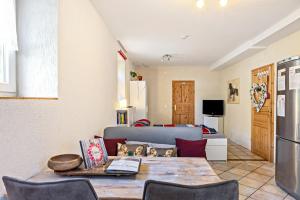 a living room with a table and a couch at Belroki Ranch in Waldeck