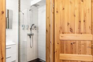 a bathroom with a shower with a wooden door at Belroki Ranch in Waldeck