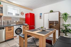 a kitchen with a table and a red refrigerator at Kastanie in Selb