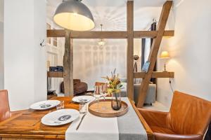 a dining room with a wooden table and chairs at Gutshaus Benckendorf - Wohnung Erde in Dassow