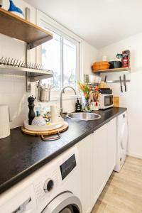 a kitchen with a sink and a washing machine at Chiara's Wellness Studio Sauna and Outdoor Bath in Sorrento