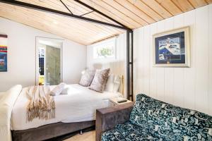 a bedroom with a bed and a chair at Chiara's Wellness Studio Sauna and Outdoor Bath in Sorrento