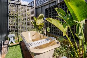 a garden with a toilet and a plant on a fence at Chiara's Wellness Studio Sauna and Outdoor Bath in Sorrento