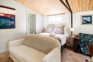 a bedroom with a bed and a couch at Chiara's Wellness Studio Sauna and Outdoor Bath in Sorrento