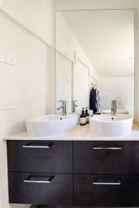 a bathroom with two sinks and a large mirror at Chiara's Wellness Studio Sauna and Outdoor Bath in Sorrento +12 photos