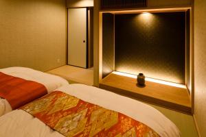 Postelja oz. postelje v sobi nastanitve The Besso Soso Kyoto