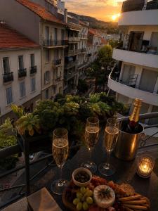 a table with glasses of wine and food on a balcony at Ciel de Cannes in Cannes