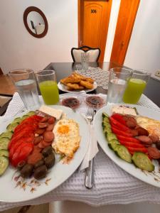 a table with two plates of breakfast food and drinks at Vila CANO Boutique in Durrës