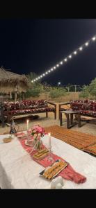 a white table with candles and food on it at منتجع النادر الريفي in Az Zulfi