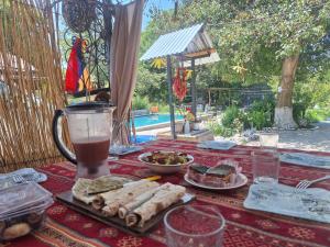 a table with food and a drink on it at Davti Toon Guesthouse in Aghitu +28 photos