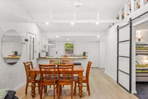 a kitchen and dining room with a table and chairs at What-A-View Cottage Halls Gap in Halls Gap