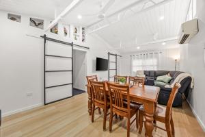 a kitchen and dining room with a table and chairs at What-A-View Cottage Halls Gap in Halls Gap