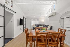 a dining room and living room with a table and chairs at What-A-View Cottage Halls Gap in Halls Gap +20 photos