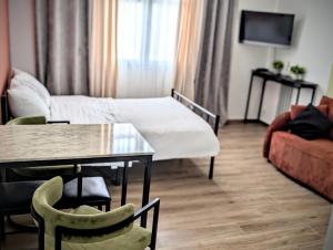 a living room with a table and a couch at Ciel de Cannes in Cannes