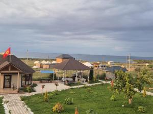 a view of a house with a yard with a patio at Guest House Archa in Tong +12 photos