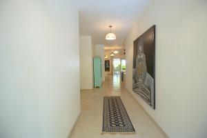 a hallway with a rug on the floor at Villa Zuri at Papa Remo in Watamu