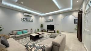a living room with a couch and a tv at Al Hawli pool gathering in Salalah