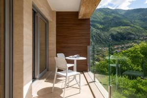 a balcony with two chairs and a table with a view at Vinyl & Wine Retreat by THE HOUSE Experience Collection in Škaljari
