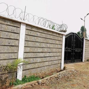 a wooden fence with a gate and barbed wire at Cozy stays in Giachumi +1 photo
