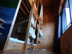 a room with a bunk bed and a ladder at EkimaehouseSamaru in Shimanto-cho +38 photos